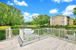 Scenic view from the balcony of Corner Apt #2805 at Village Springs Apartments, Orlando, featuring lush landscaping and a water canal.