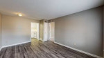 Spacious living area with updated vinyl plank flooring in an El Dorado apartment in Memphis.