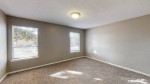 Spacious living area in a Memphis apartment with updated flooring and natural light from windows.