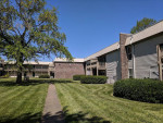 View of Tivoli Apartments in Virginia Beach, featuring well-maintained grounds and ample parking space.