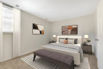 Modern bedroom in an apartment featuring central air conditioning, elegant decor and natural light.