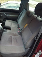 Inside view of a 2005 Toyota Tacoma showing the rear seats and interior details.