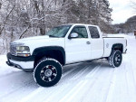 Chevrolet Classic truck in snowy landscape, showcasing custom modifications and performance engine.