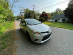 2016 Toyota Corolla in excellent condition for sale with new tires and 100,000 miles on a residential street.