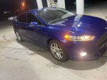 2016 Ford Fusion SE FWD in blue at a gas station with leather interior and eco boost engine.