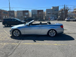 2000 BMW 3 Series 328i convertible in silver parked, showcasing its stylish design and low mileage of 96,000.