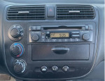 Interior dashboard of a 2004 Honda Civic LX with radio and climate controls in excellent condition