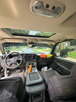 Interior view of a 2006 Chevrolet Silverado 1500 showing dashboard and seats with sunroof.