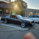 1985 Buick Grand National with T-tops, solid condition, parked on the street with stylish wheels.