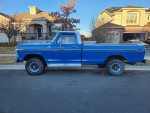 1977 Ford F150 4x4 pickup truck in blue parked on a residential street