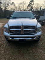 Front view of a 2005 Dodge Ram 3500 Laramie work truck with 67,000 miles, parked on grass.