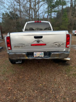 Rear view of a 2005 Dodge Ram 3500 Laramie truck, showcasing its sturdy build and 4WD capabilities.