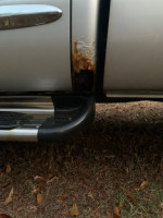 Rusty area on the side of a 2005 Dodge Ram 3500 Laramie work truck