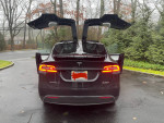 2016 fully loaded Tesla Model X P100D with motorized spoiler and supercharging features parked outdoors.
