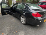 2009 Infiniti G37 sedan with black exterior and open doors, showcasing interior features.