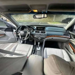 Interior view of a Honda Accord showing leather seats, dashboard, and modern features.