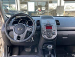Interior view of a 2010 Kia Soul with dashboard and controls, featuring black seating and modern design.