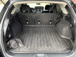 Spacious cargo area of a 2017 Subaru Outback 2.5i, featuring a rubber mat and fold-flat seats.