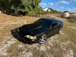 1994 Ford Mustang GT in black, featuring a 347CI supercharged engine, with 90,000 miles, parked outdoors.