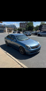 2003 Infiniti G35 sedan in blue color parked on the street, showing clean exterior and wheels.