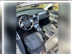 Interior view of a 2010 Chrysler Sebring Limited with leather seats and dashboard details.