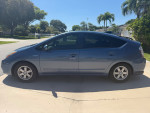 2007 Toyota Prius hatchback in good condition, parked in a residential area with palm trees.