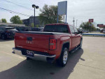 2014 GMC Sierra 1500 SLE in Fire Red parked, showcasing sleek design and advanced features.