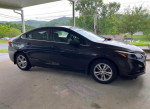 2014 Chevrolet Cruze 1LT in good condition, ready for sale, parked under a shelter.