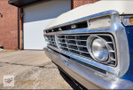 Close-up of a 1991 Ford F-250 XL front grille and headlight, showcasing its vintage design.