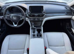 Interior view of a 2018 Honda Civic EX-L with clean leather seats and modern dashboard features.