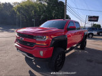 2019 Chevy Silverado 1500 Rocky Ridge in red, showcasing aggressive off-road stance and black accents.