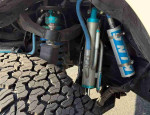Close-up of 2020 Toyota Tacoma SR suspension system showcasing off-road capabilities and tire tread.