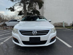 Front view of a white 2009 Volkswagen CC Luxury sedan parked, showcasing its sleek design and well-maintained exterior.