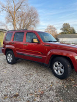 2009 Jeep Liberty in burnt orange, 83,000 miles, excellent condition with spacious dark gray interior.