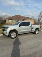 2019 Chevrolet Silverado 1500 parked on street, showcasing its silver exterior and sporty design