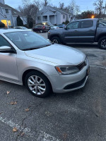 2011 Volkswagen Jetta in silver parked, showcasing its design and exterior condition for sale.