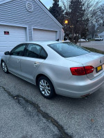 2011 Volkswagen Jetta parked outside, showing silver exterior and good condition, ideal for buyers looking for a reliable car.