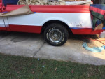 1969 GMC 1500 truck with 350 motor, stored in garage, showing new front fender and partially restored wheel.