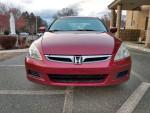 Front view of a 2006 Honda Accord EXL in red, showcasing its sleek design and features.