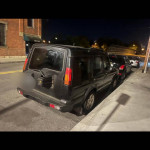 2004 Land Rover Discovery parked on street, looking for trade for a reliable vehicle like a Honda or Toyota.
