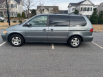 2001 Honda Odyssey EX FWD minivan with 53,000 miles parked in a residential area.