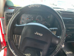 Interior view of a 2006 Jeep Wrangler Sport showcasing the steering wheel and dashboard instruments.