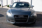 Front view of a 2009 Audi TT 3.2L Roadster in Aruba Blue Pearl with a sleek black roof.