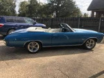 1972 Chevrolet Chevelle convertible in blue metallic with white interior parked outside
