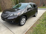 2014 Honda CR-V EX-L FWD parked, showcasing its sleek design and features like leather seats and rearview camera.