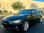 2014 BMW 328I in black color with 103K miles, parked outside, showcasing its clean exterior and design.