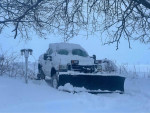 2002 Ford F250 plow truck in snow, featuring Western Ultramount plow, good condition with minor rust, ready for winter.