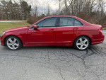 2010 Mercedes-Benz C300 Sport 4Matic in red, showcasing sleek design and modern features on a cracked pavement