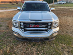 Front view of a GMC Sierra 1500 pickup truck with black leather interior and a new certified transmission.