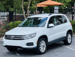 2015 Volkswagen Tiguan SE 4Motion AWD in white with black leather interior, parked near a pool.